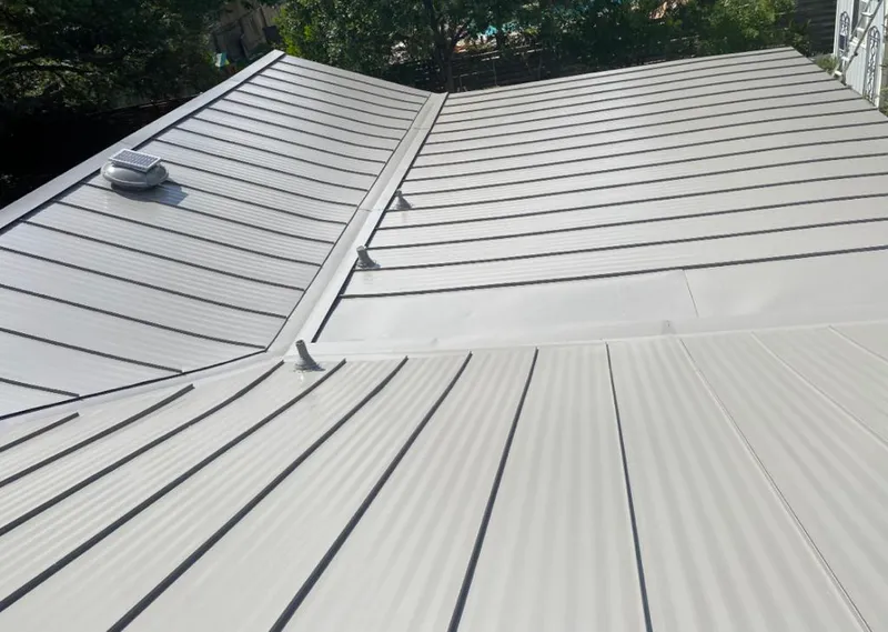 Solar attic fan installed on a metal roof for Roof Ventilation in Meredith